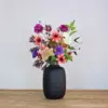 Zijden boeket met oranje/bruine, paarse en roze kleuren